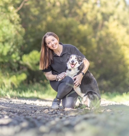 Certified dog trainer working with a client dog on lead